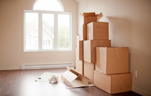 Packed office furniture and equipment prepared for a Chelsea business move