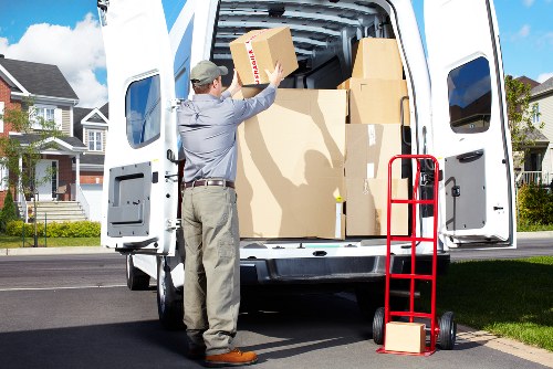 Mover handling boxes and furniture in Chelsea near tight parking