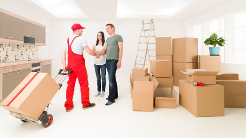 Chelsea removal specialists handling furniture and boxes during a local move